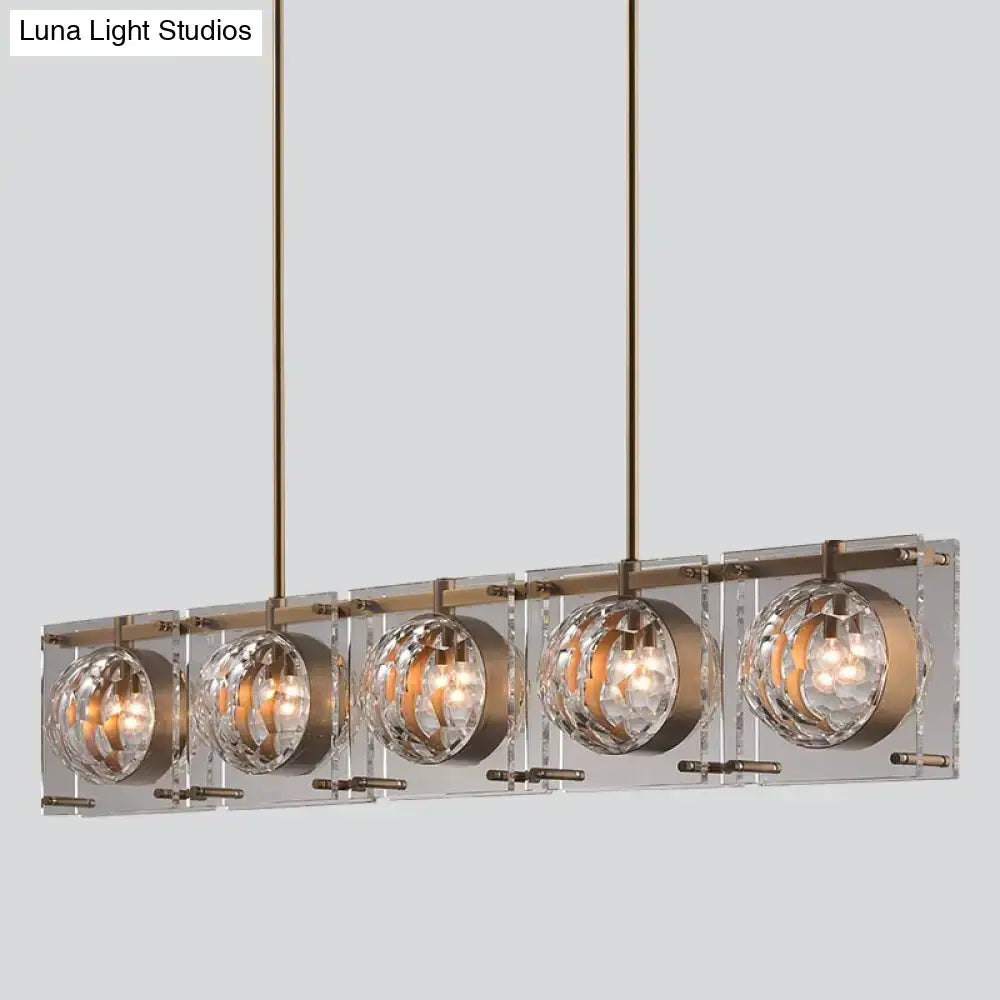 DecorBites™ hexagon glass ball island light fixture with five clear crystal globes in brushed brass finish
