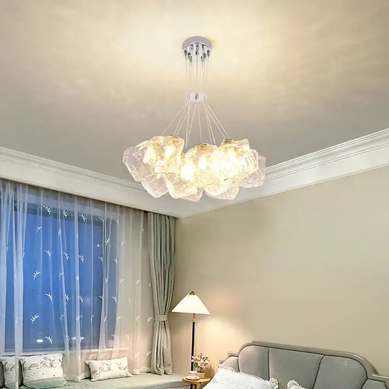 A modern decorbites iced crystal chandelier with translucent cloud-like glass shades and a sleek chrome fixture for living rooms