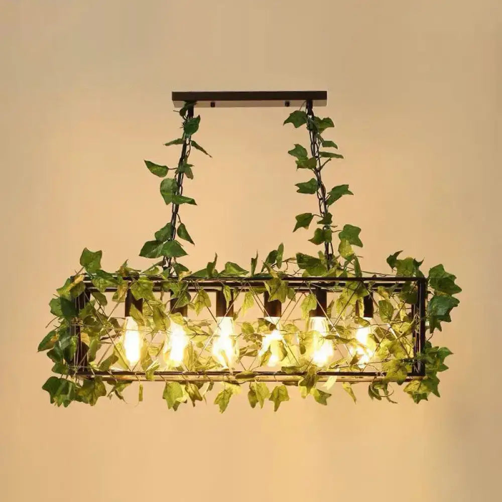 Rectangular wrought iron cage island pendant light with lush green plant decoration and glowing led incandescent bulbs