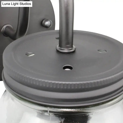 Black metal jar lid with ribbed edge and mounting holes securing clear glass for industrial black jar shade wall lamp