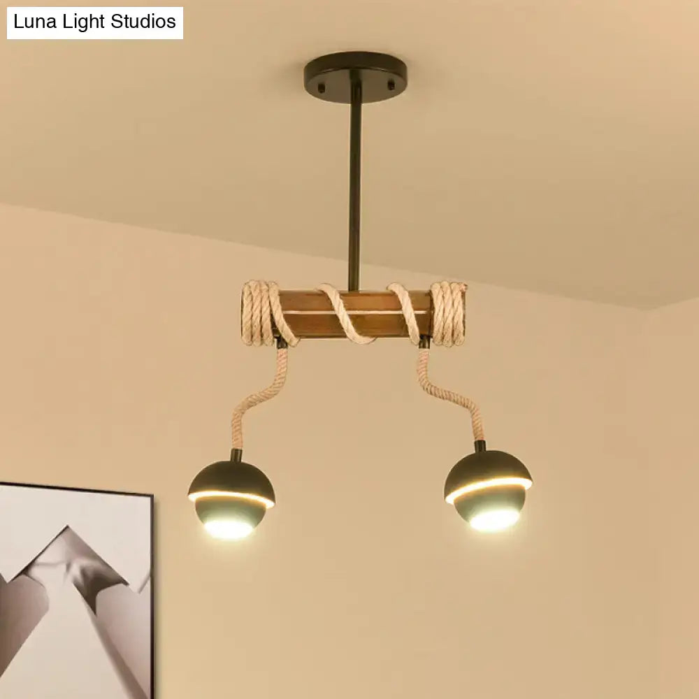 DecorBites™ industrial linear chandelier with wooden beam, twisted rope accents, and two black globe bulbs in black iron
