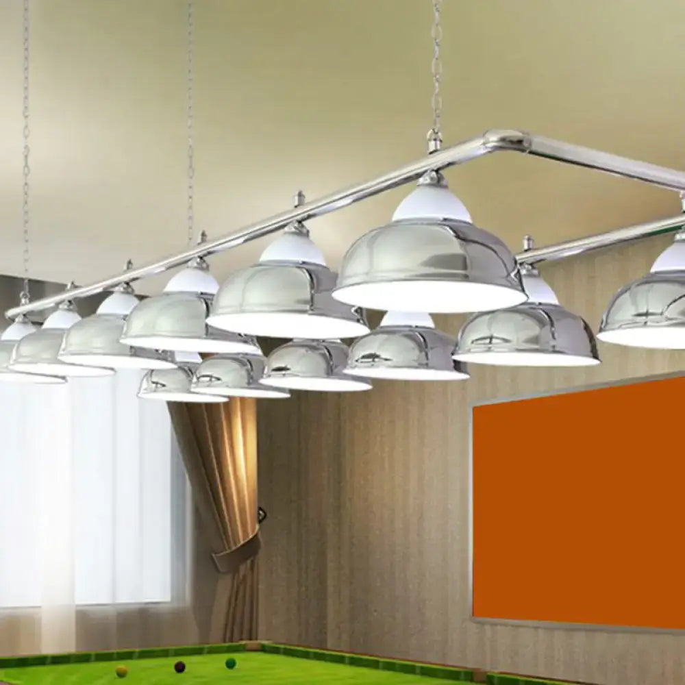 Chrome-finished dome-shaped DecorBites™ metal mirrored bowl pendant lights suspended above a pool table