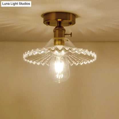 DecorBites™ one-light ceiling light with vintage brass finish and clear scalloped ribbed glass shade
