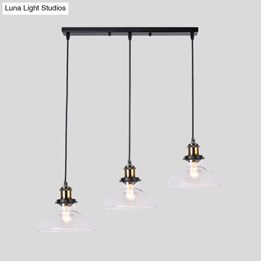 Black metal bar with three clear glass hanging lamps featuring industrial style brass round barn admix pendant lights