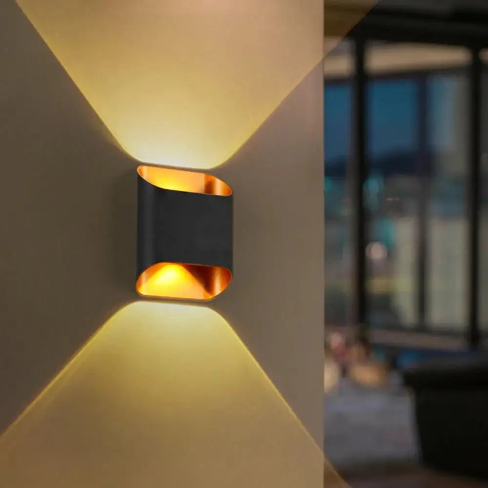 DecorBites™ IP65 modern black and gold led outdoor wall lights with sleek angular design casting warm geometric light patterns