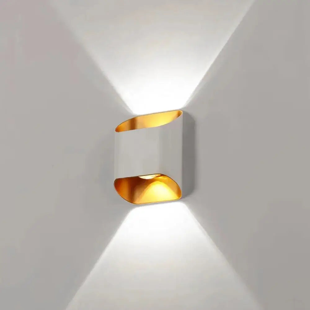 Modern DecorBites™ IP65 led outdoor wall lights with sleek white body and gold accents casting warm directional light