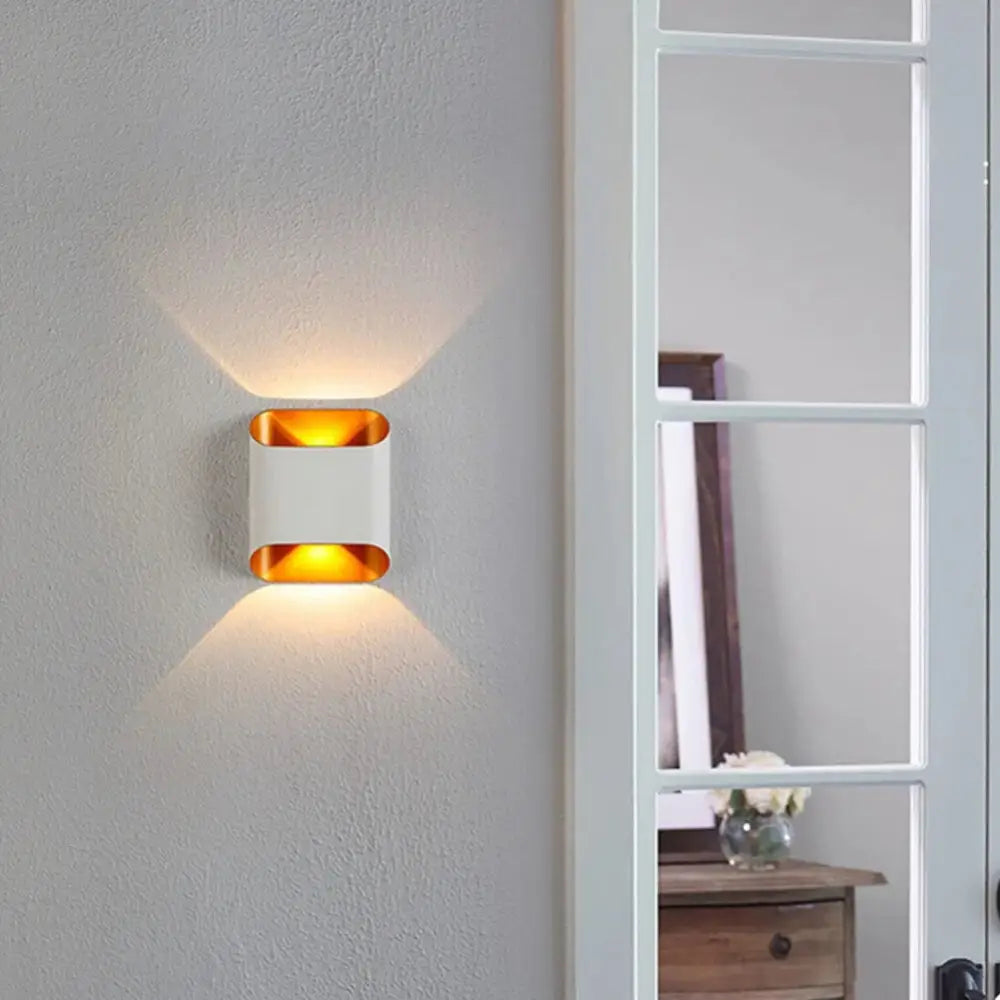 Modern white and gold accent DecorBites ip65 led outdoor wall lights with sleek rectangular design emitting warm ambient light