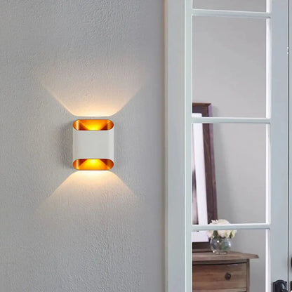 Modern white and gold accent DecorBites ip65 led outdoor wall lights with sleek rectangular design emitting warm ambient light