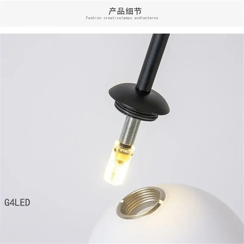 A sleek black g4 led bulb with metallic threaded base emitting warm light in decorbites iron balance chandelier