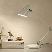 White adjustable iron bell shaped desk lamp with swing arm and metallic joints for study room desk by DecorBites
