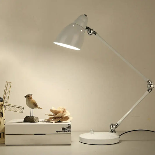White adjustable iron bell shaped desk lamp with swing arm and metallic joints for study room desk by DecorBites