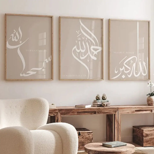Three framed islamic dhikr tasbih calligraphy wall art prints with white script on beige backgrounds in light wood frames