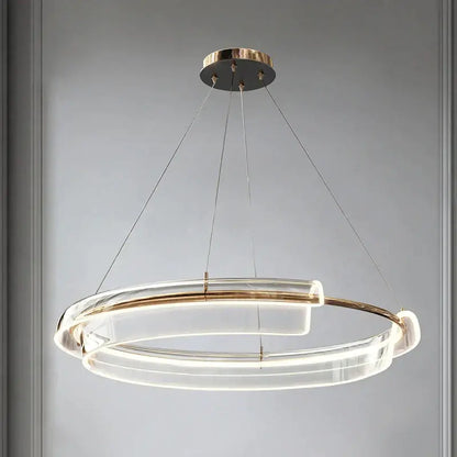 Modern double-ring pendant light with clear acrylic rings and gold-toned metal accents decorbites italian minimalist chandelier