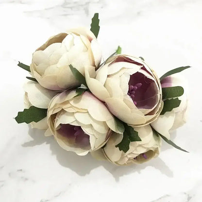 A delicate cluster of decorbites ivory flower cherry artificial peonies with purple centers and green leaves for wedding decor