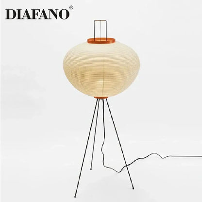 Diafano floor lamp with a cream japanese style paper lantern shade and black metal tripod legs for living room lighting