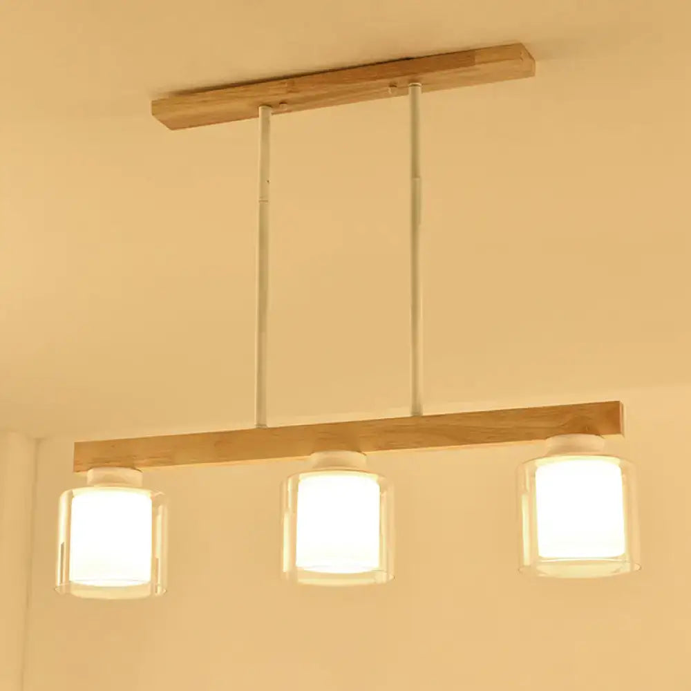 Minimalist DecorBites™ white glass cylinder led pendant light with three clear glass cube shades for dining room island