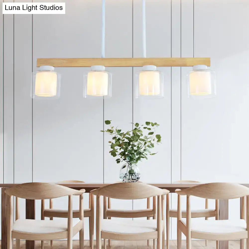 Modern wooden pendant light with four clear warm glass shades featuring decorbites white glass cylinder led design