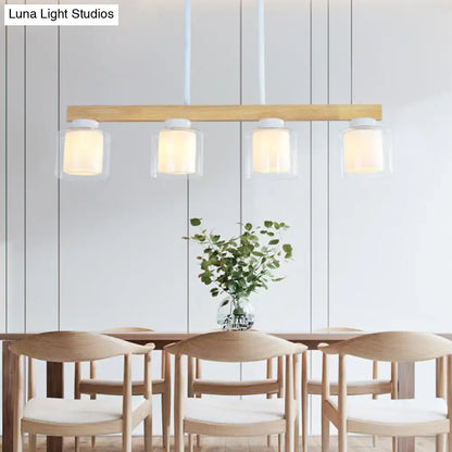 Modern wooden pendant light with four clear warm glass shades featuring decorbites white glass cylinder led design