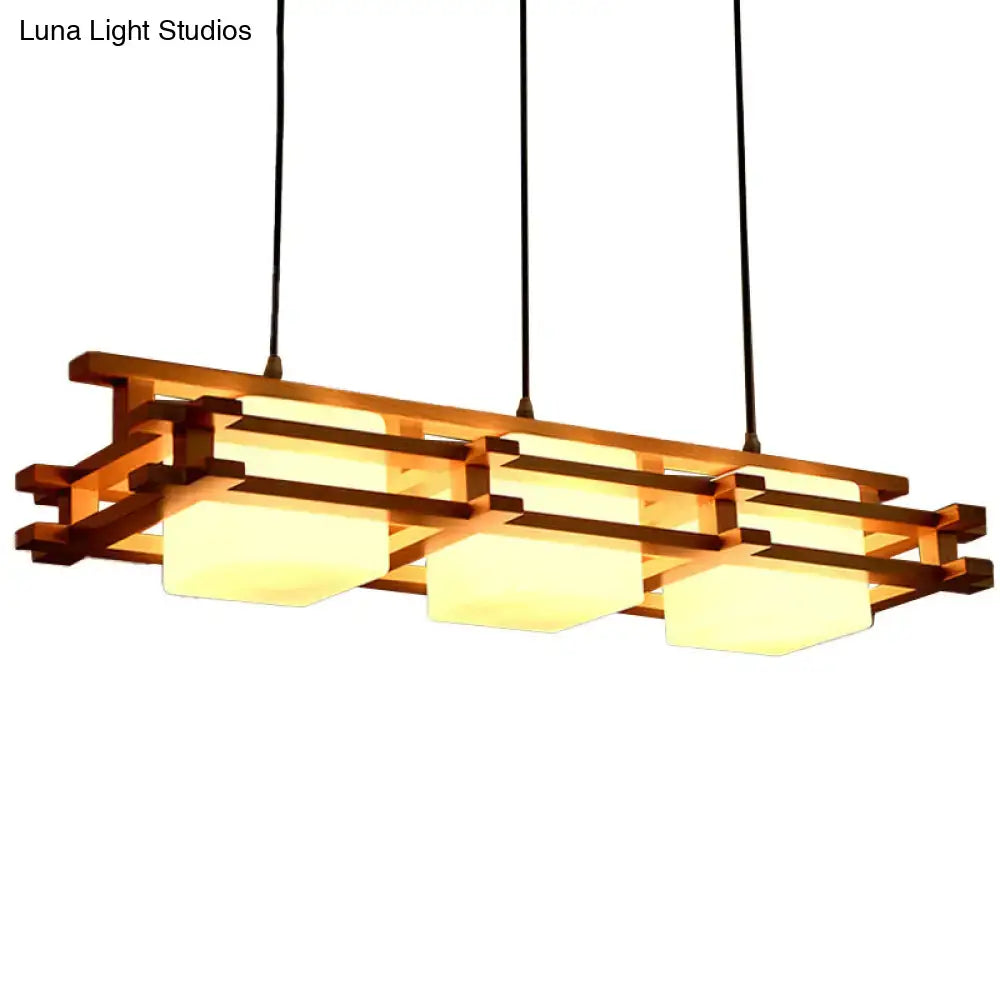 DecorBites™ Japanese wood ceiling pendant light with warm-toned wooden frame and three glowing frosted glass panels