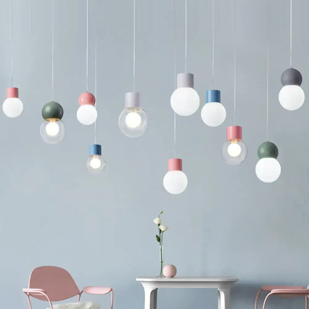 A collection of colorful macaron ceiling pendant lights with matte glass shades in pink blue green and gray for kids bedside pendulum use