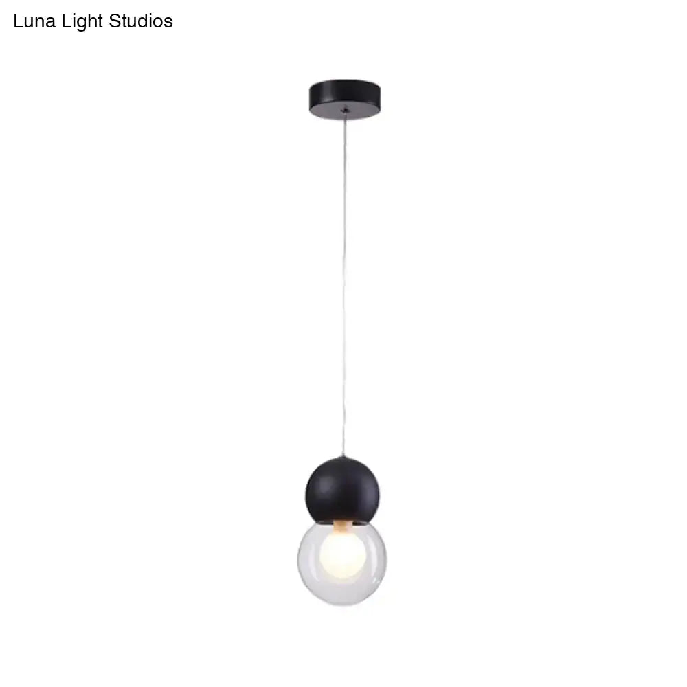 Black spherical kids bedside pendulum light with clear glass globe and black cord from macaron ceiling pendant series
