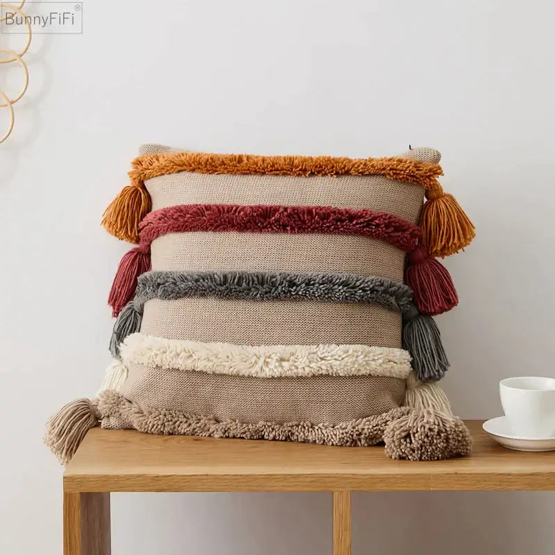 Beige woven decorbites knit boho cushion cover with horizontal orange red gray cream stripes and tassels for living room
