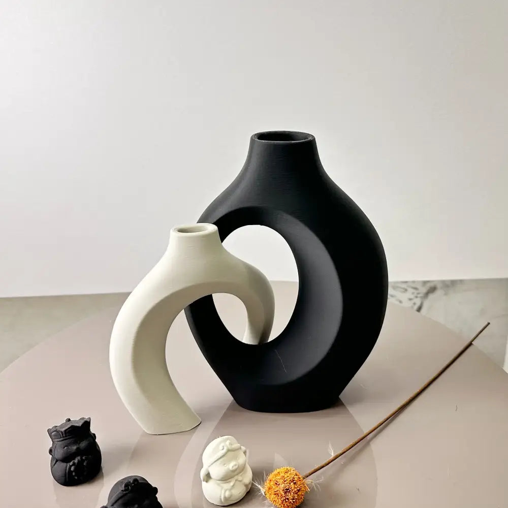 Black ceramic large dried vase with sleek curved design and central cutout in the DecorBites™ dried vase set for home and office