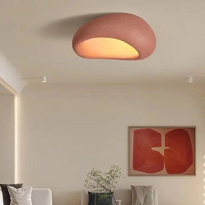 A warm terracotta decorbites led ceiling light with a smooth organic shape and soft glow for indoor home decor