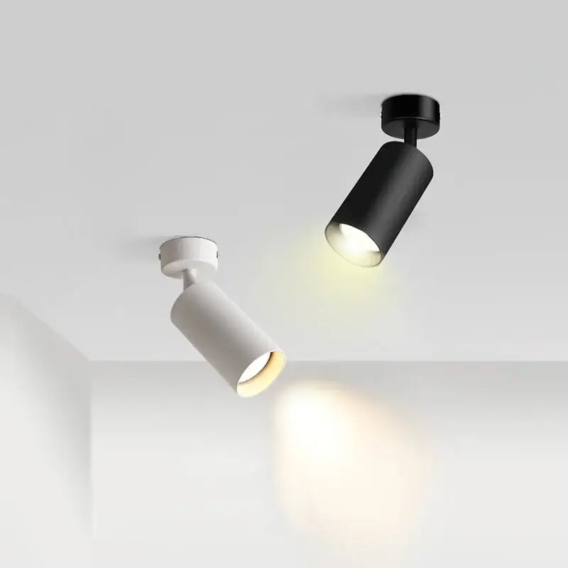 Decorbites led ceiling spotlight with two modern black and white cylindrical track lights emitting warm glow