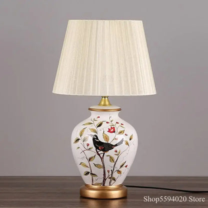 White ceramic decorbites led ceramic table lamp with hand-painted black bird floral design and gold trim accents