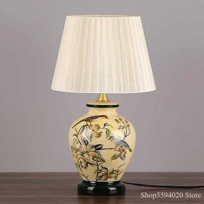 Cream-colored decorbites led ceramic table lamp with hand-painted birds and flowers and pleated off-white shade