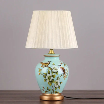 DecorBites led ceramic table lamp in light blue with hand-painted birds white flowers and gold-toned metal accents