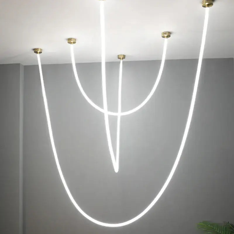 Modern white DecorBites LED chandelier pendant light with curved glowing lines and brass ceiling mounts for versatile decor
