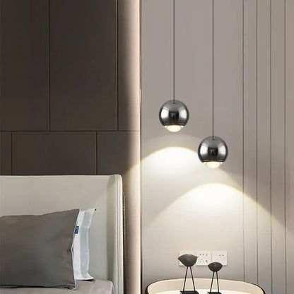 Two sleek spherical chrome pendant lights hanging from ceiling in decorbites led chandelier modern design