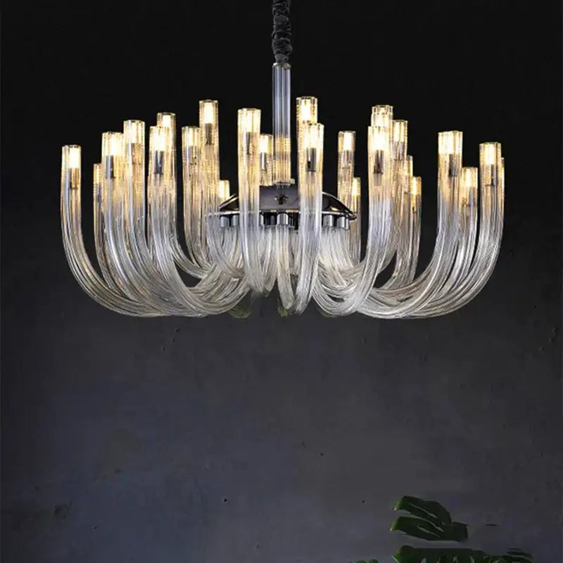 Clear glass decorbites led chandelier with curved translucent arms and central metallic fixture lighting fixture for bedroom
