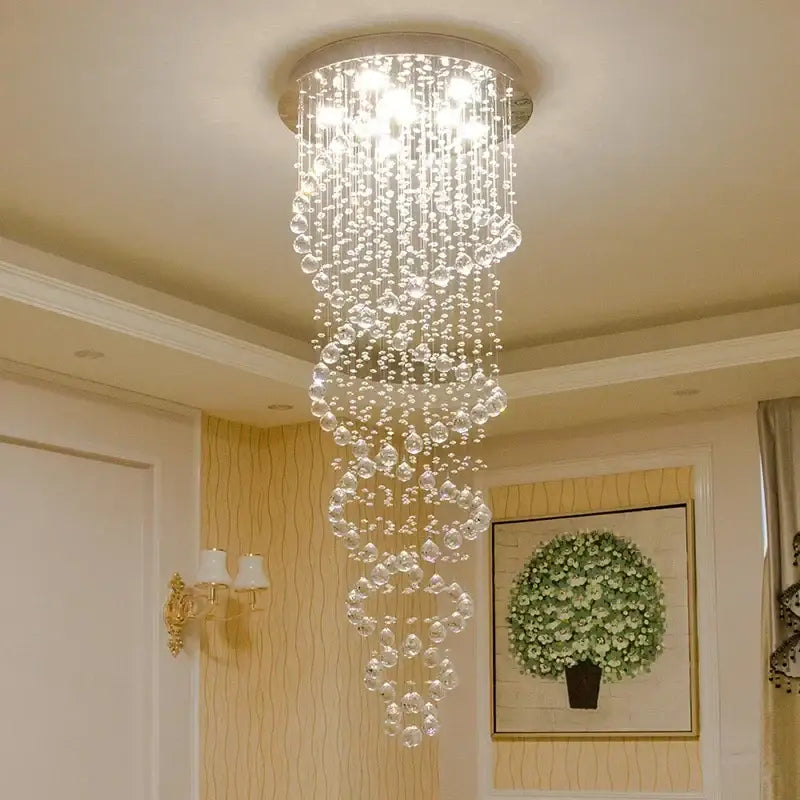 A cascading decorbites led chandelier with clear faceted beads and a circular metallic base for luxury home decor