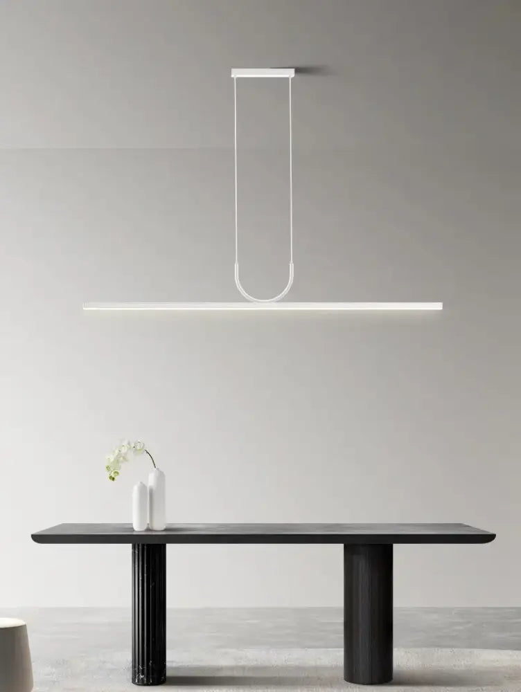 Minimalist white led chandelier with sleek curved design hanging above dark table for kitchen islands nordic minimalist