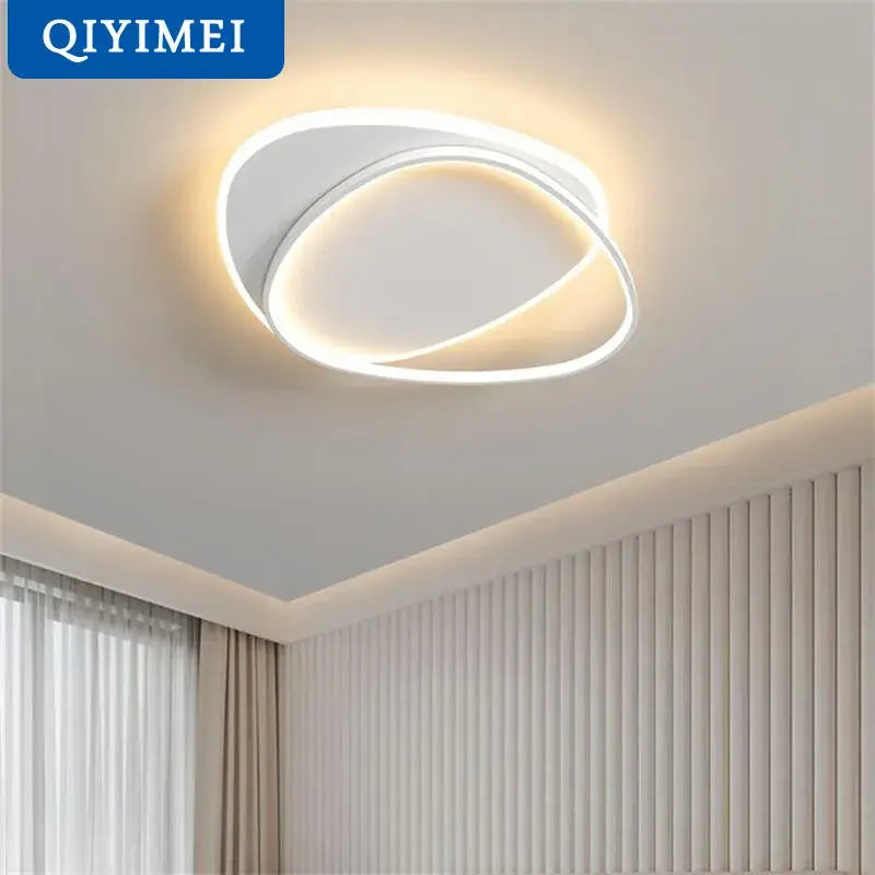 Modern white DecorBites LED chandelier with sleek double-ring design emits warm ambient glow for bedroom and living room lighting