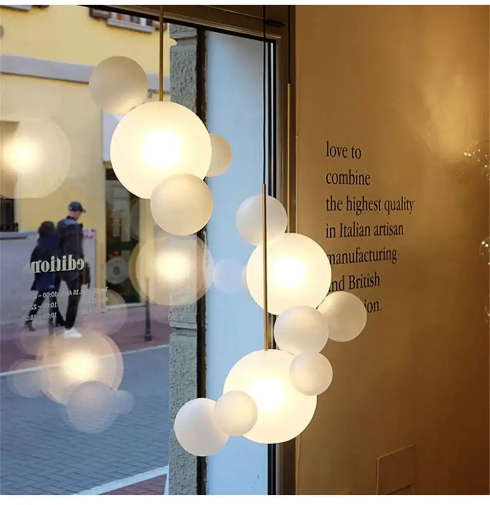 Modern spherical led chandelier with frosted glass orbs and brass finish for nordic decor by DecorBites