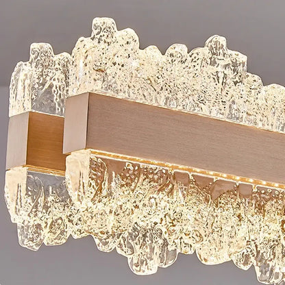 Modern rectangular decorbites led chandelier with textured crystal glass panels and central brushed brass bar for living room decor