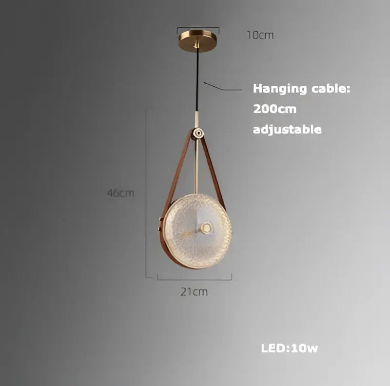 A decorbites led chandelier with circular textured glass shade, brass frame, and brown leather straps for dining room lighting