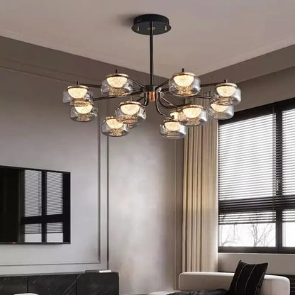 Modern black metal DecorBites LED chandelier lighting with clear glass globe shades emitting warm light for dining room