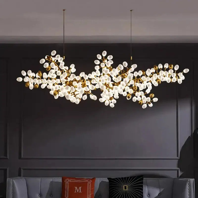 Gold-toned decorbites led chandelier with frosted glass globe bulbs in a branching design for living room lighting