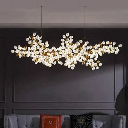 Gold-toned decorbites led chandelier with frosted glass globe bulbs in a branching design for living room lighting
