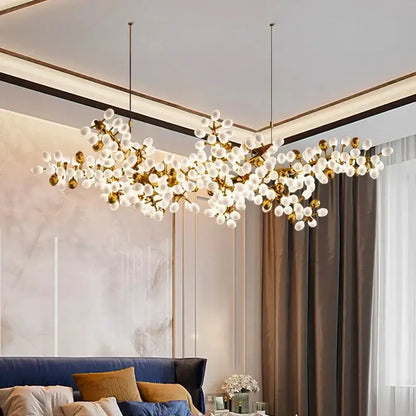 Gold-toned DecorBites LED chandelier lighting with frosted glass globe bulbs in a branching design for living spaces