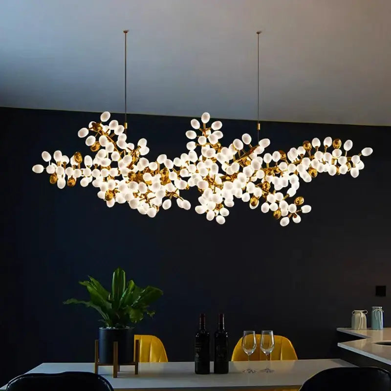 Gold-toned DecorBites LED chandelier lighting with frosted glass globes resembling blossoms for living room and bedroom