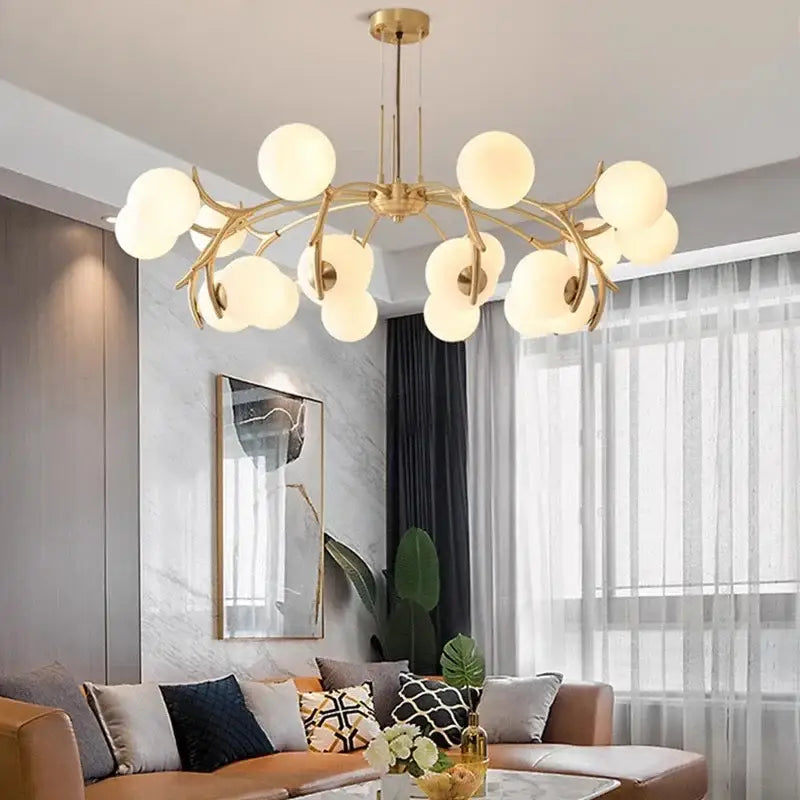 Gold-toned DecorBites led chandelier lighting with frosted glass globes in a branching design for living room décor