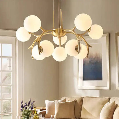 Gold-toned decorbites led chandelier with frosted glass globes in a branching design for living room and dining room lighting