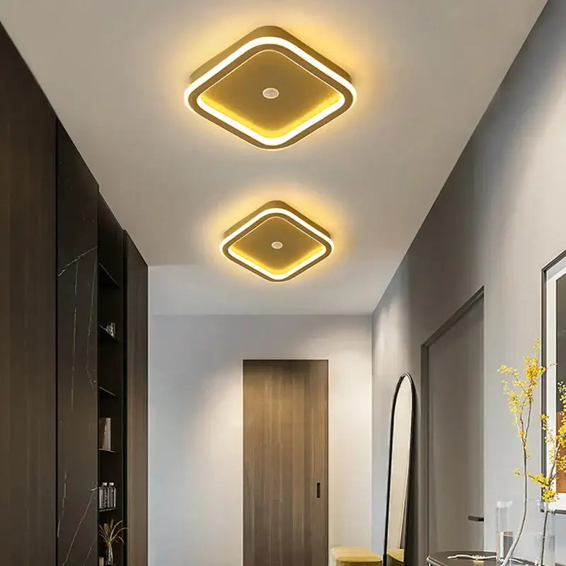 Two modern square decorbites led chandelier lights with gold frame and warm yellow led glow for indoor lighting