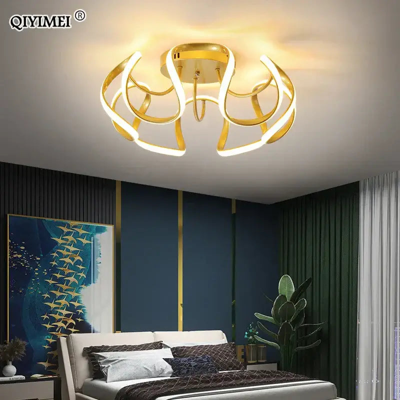 Gold-toned decorbites led chandelier with sleek curved led rings and central base for modern indoor lighting